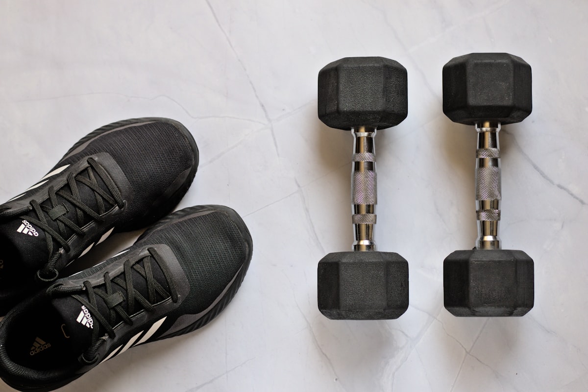 Professional fitness trainer guiding client through exercise